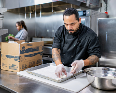 Chef placing biscuits on a pan