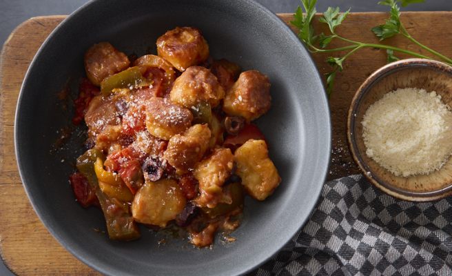 Fried Mortadella sandwich sitting on a small, white plate.